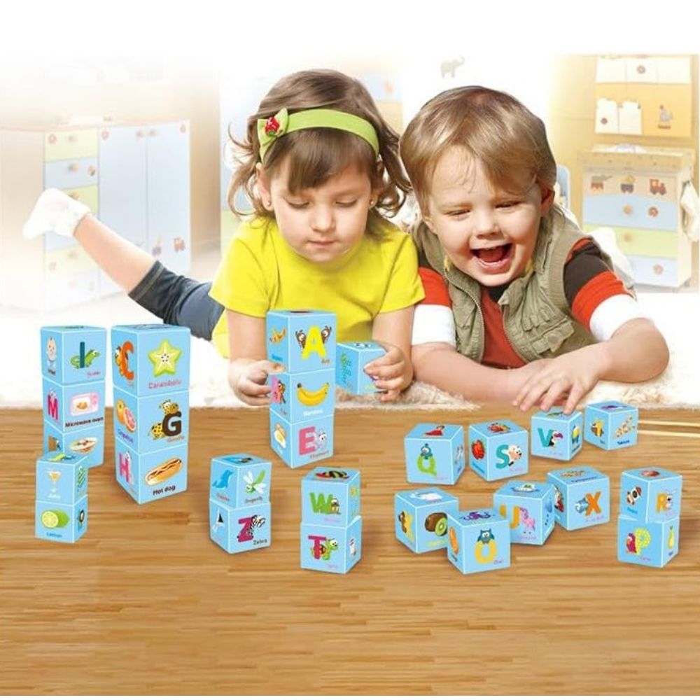 Alphabet cube blocks displayed side-angle showing printed letters