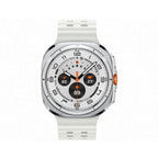 Samsung Galaxy Watch Ultra 47mm Titanium White on wireless charging puck with green charging animation on display.