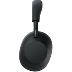 Sony WH-1000XM6 Premium Noise Cancelling Headphones – Black connected with a 3.5 mm audio cable for wired listening.