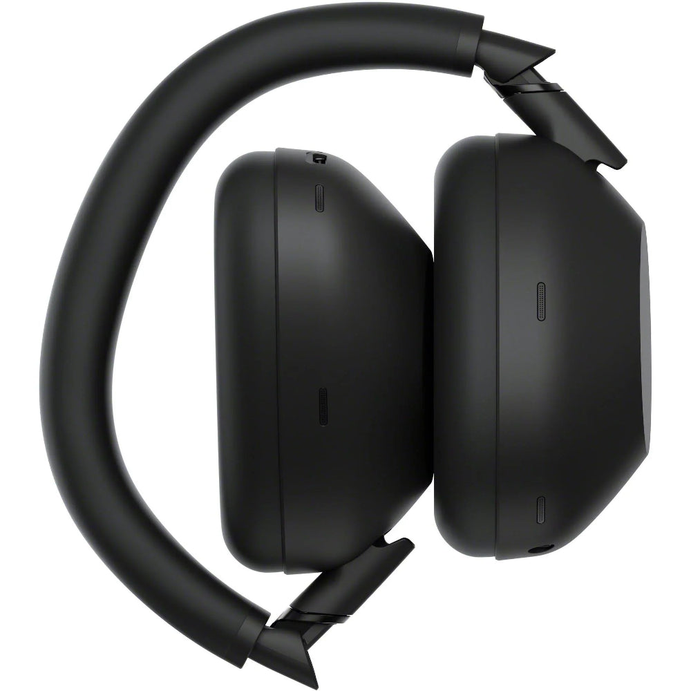 Image of Sony WH-1000XM6 Black standing upright on one earcup with the headband arched above, showcasing minimalist styling.